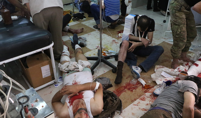 Wounded Syrian people wait to receive medical treatment at a field hospital in Aleppo (Getty Images) 