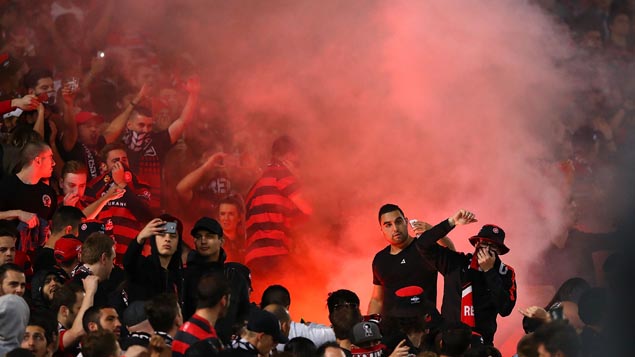 Western Sydney Wanderers fans taking selfies in front of flares during the match against Sydney FC (Getty Images)