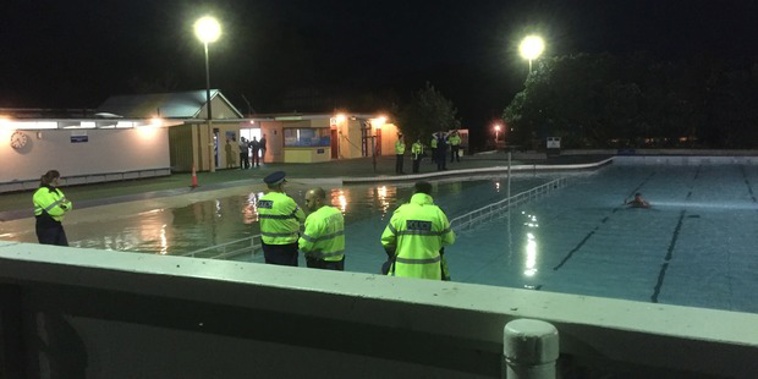 The man refused to leave the pool, standing in the middle and pulling martial arts poses instead. (NZ Herald/Jeremy Batten)