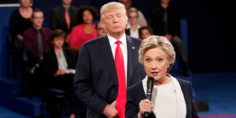 Democratic presidential nominee Hillary Clinton, right, speaks as Republican presidential nominee Donald Trump listens during the second presidential debate. Photo / AP / NZ Herald