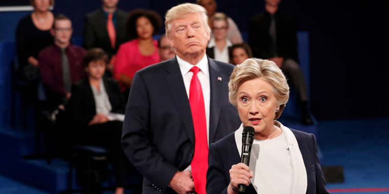 Democratic presidential nominee Hillary Clinton, right, speaks as Republican presidential nominee Donald Trump listens during the second presidential debate. Photo / AP / NZ Herald