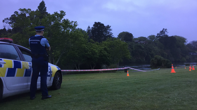 Police this morning guard there scene where a woman's body was found in the Waikato River on Ann St, Hamilton, last night (Photo / NZ Herald)