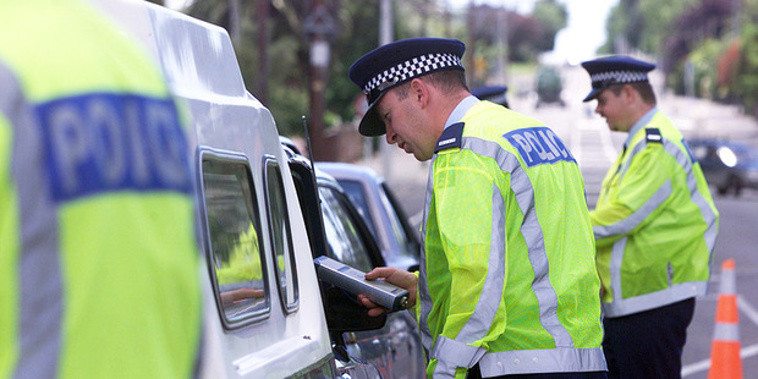 Police officers breath-testing drivers. Photo / File