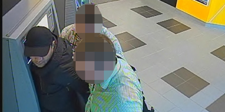 Undercover police officers arrest Bogdan Irimia using skimmed cards at an ATM (Supplied)
