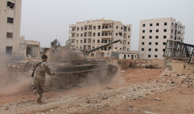 Rebel soldiers with a captured tank prepare to attack (Getty Images) 