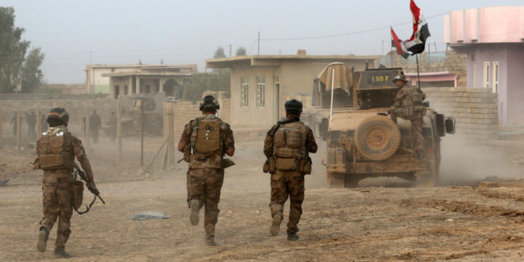 Iraq's elite counterterrorism forces advance toward Islamic State positions in the village of Tob Zawa, about 9 kilometres from Mosul. (NZ Herald/AP)