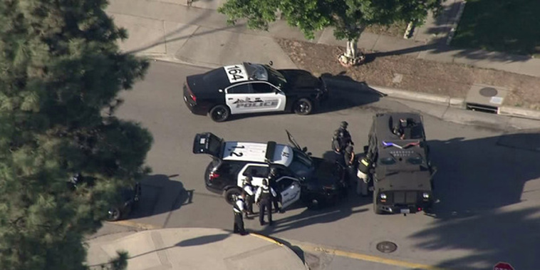 Police and SWAT vehicles were in residential area of Azusa following a shooting. Photo / KTLA
