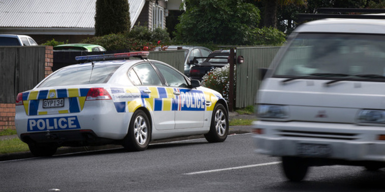 Police talk to families living on Metcalfe Rd, Ranui. Photo / Nick Reed