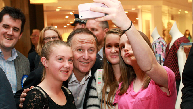 John Key taking a selfie with shoppers at Westfield mall in Lower Hutt during the 2014 election campaign (Getty Images)