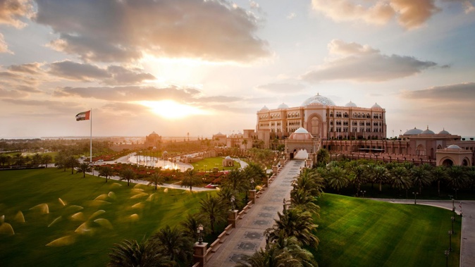 Make a date with the opulent Emirates Palace where the spectacles include gold-flaked cappuccinos, gold-dusted camel burger buns, and even an ATM machine dispensing gold bars (Supplied)