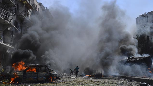 Rubble and smoke after a building was bombed in Aleppo (Getty Images) 