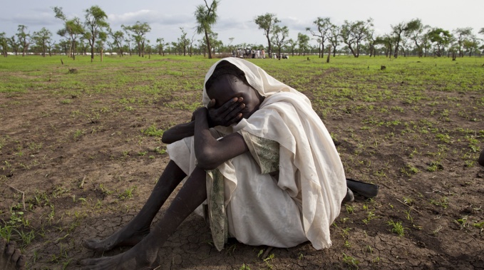 A woman grieves for her dead husband in a refugee camp in South Sudan, 2012 (Getty Images) 