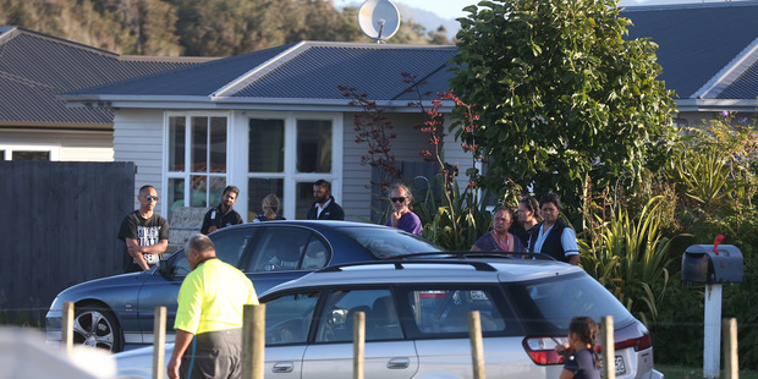 Family and friends gathered outside a house in Waiuku where a 5-month-old child died suddenly.