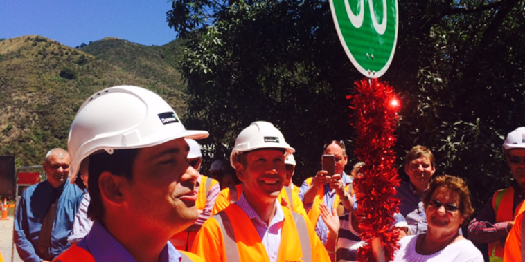 Transport Minister Simon Bridges and new Associate Transport Minister David Bennett turned a tinsel-wrapped Stop-Go sign at the Kahutara Bridge to officially reopen SH1 south of Kaikoura.