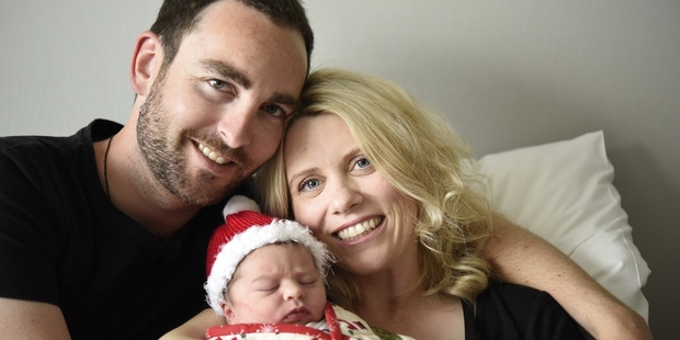 Rick and Sam Clark cradle baby Mila. Photo / George Novak