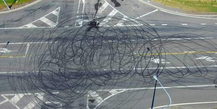 Aerial photographs show the State Highway one crossroad, notorious for crashes, has had its road markings blacked out by circular skid marks. (Facebook)