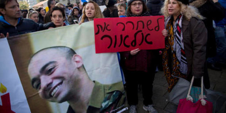 Hardline nationalist supporters of Israeli army medic Sgt. Elor Azaria hold his photo and shout slogans outside the Israeli military court in Tel Aviv (AP).