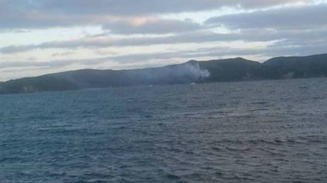 Helicopters work to put out a fire at Vivian Bay, Kawau Island (Facebook)