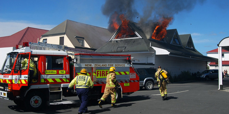 Russell volunteer firemen rushing into action at a fire in York Street, Russell. (Rex Cooper, file photo)