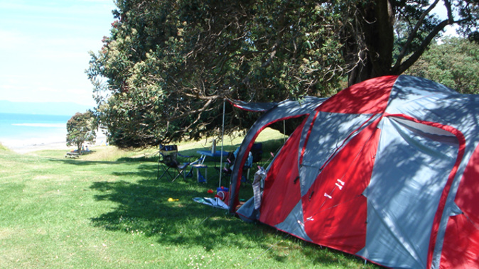 A camper at Tapapakanga Regional Park Beach (File photo - Auckland Council)