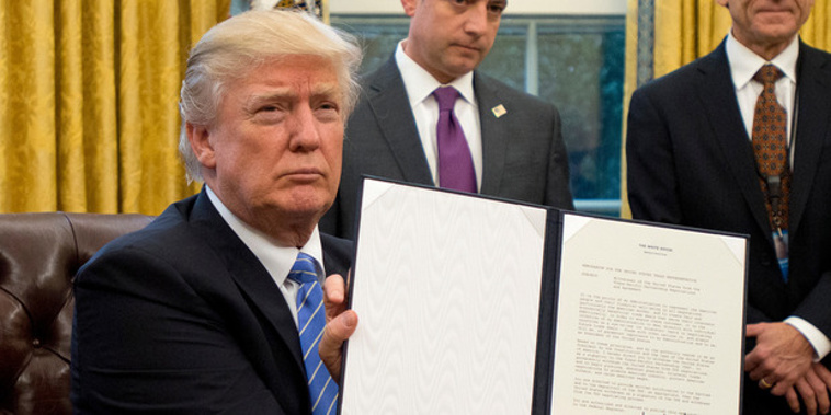US President Donald Trump shows the Executive Order withdrawing the US from the Trans-Pacific Partnership (TPP). Photo / Getty