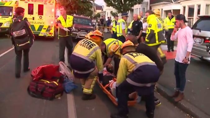 Emergency services tend to victims of a balcony collapse in Dunedin's Castle St. Photo / NZH