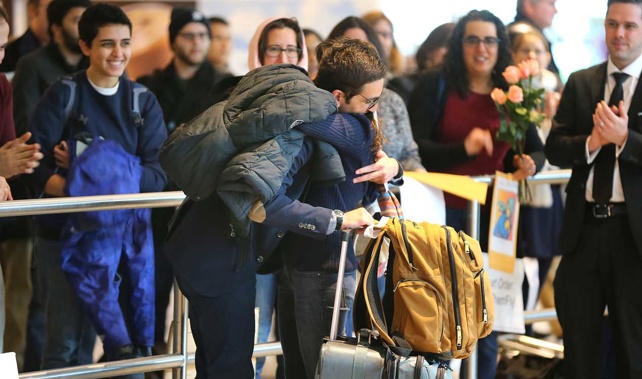 An Iranian student caught in the ban is greeted after being allowed through customs at Logan International Airport, Boston (Getty Images) 