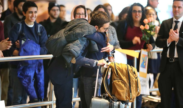 An Iranian student caught in the ban is greeted after being allowed through customs at Logan International Airport, Boston (Getty Images)