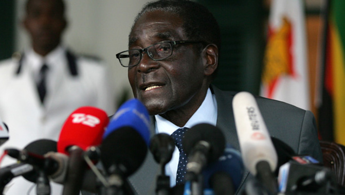 Robert Mugabe's (pictured) secret police officer was in New Zealand despite committing heinous crimes (Getty Images).