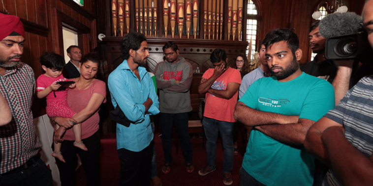 The Indian students who have received deportation orders wait at the Auckland Unitarian Church in Ponsonby after one of the students was arrested earlier this morning (Brett Phibbs).
