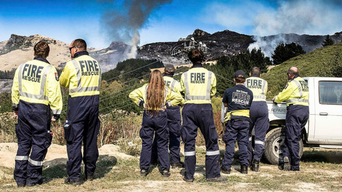Fire crews watch wild fires on the Port Hills. Picture / Martin Hunter