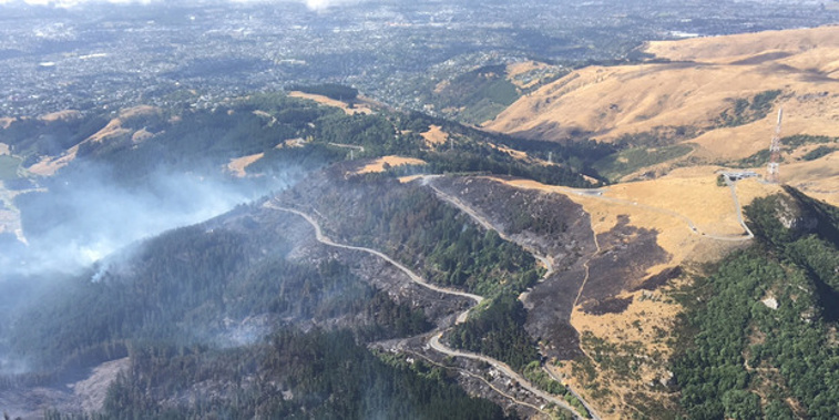 Aerial view of the top of Adventure Park Christchurch after days of bush fires. Sugarloaf radio tower is to the right (Chelsea Daniels).