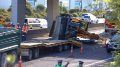 The digger hit the Penrose overpass on the southbound lanes of Auckland's Southern Motorway, blocking traffic. Photo / Nick Reed