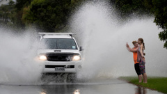 Sisters Lily-Portia McLaughlin, 17 and Ella-Grace McLauglin,14, have some fun as drivers make their way through Portland Road, Remuera. Photo / Brett Phibbs