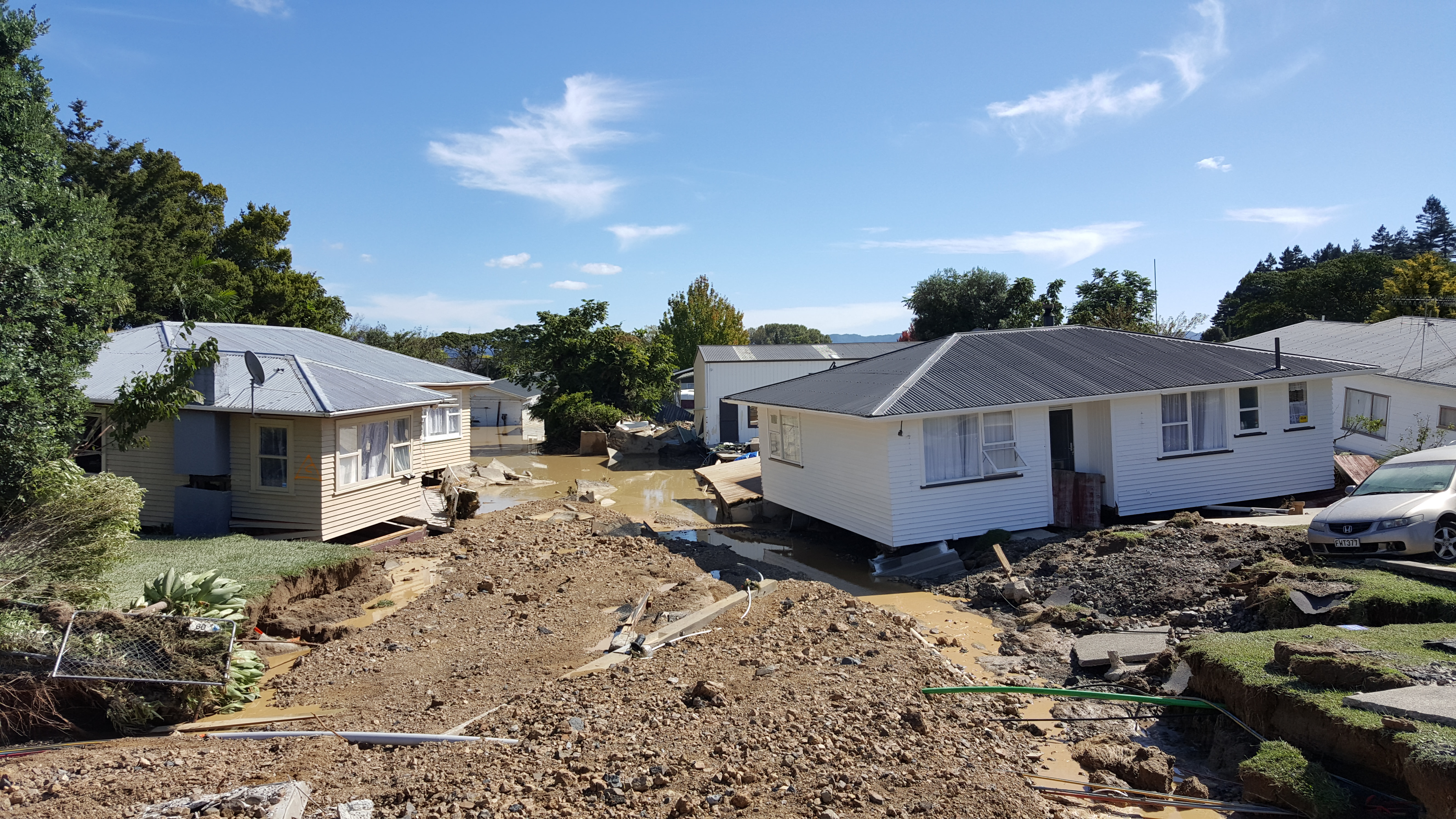 Awakeri and Edgecumbe residents queue for brief access their homes. (Photo/George Novak)
