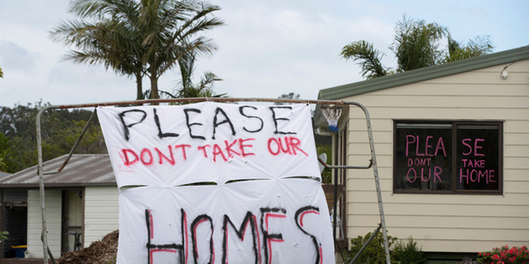 Protest signs outside Oratia properties, which will be affected by the proposed Watercare development. Photo / Brett Phibbs
