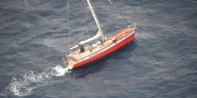 The relieved yachtie waving furiously to Orion crew from his stricken vessel. Photo / Supplied