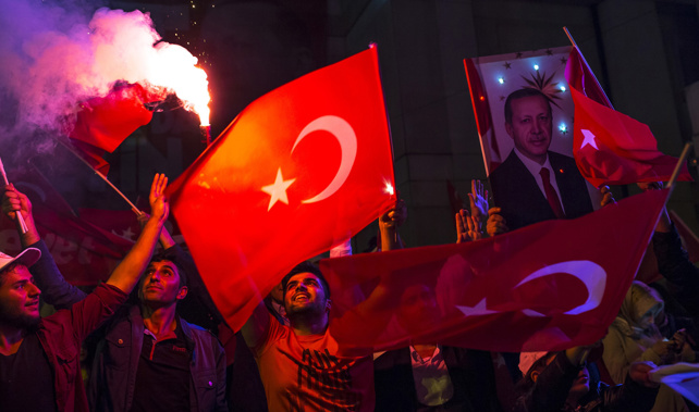 'Yes' vote supporters hold a portrait of President Tayyip Erdogan (Getty Images)