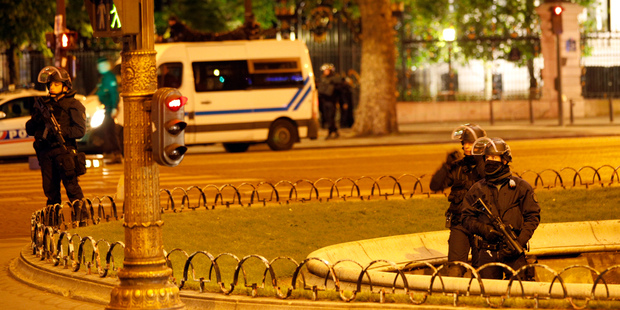 Police officers take positions near the Champs Elysees avenue in Paris, France. Photo / AP