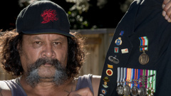 Manu Toko sits with his father's medals. (Brett Phibbs)