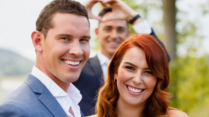 The Bachelor's winning couple Zac Franich and Viarni Bright, with host Dominic Bowden in the background. (NZH)