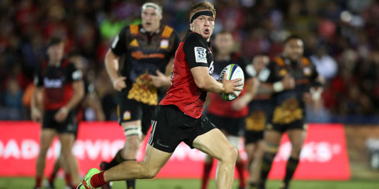 Jack Goodhue of the Crusaders makes a break. Photo / Getty