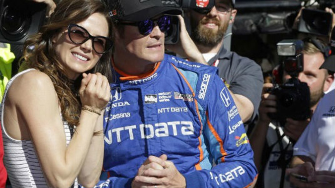 Scott Dixon, pictured here with his wife Emma, was robbed at gunpoint in Indianapolis (AP).