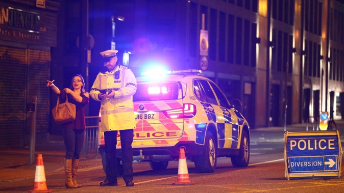 Police stand at a cordoned-off street close to Manchester Arena (Photo / AP)