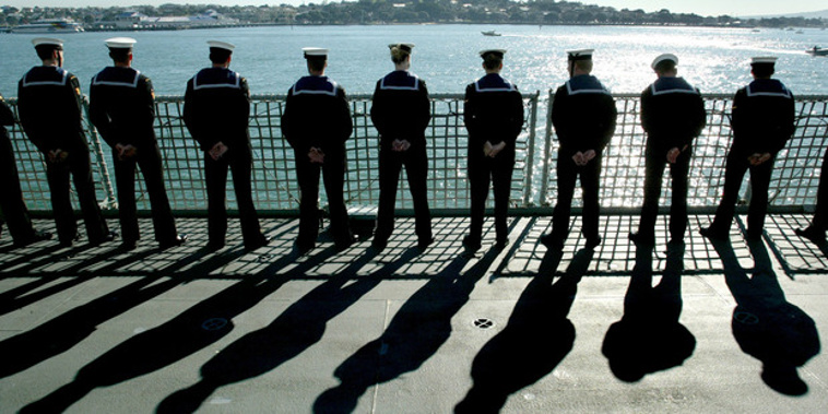 HMNZS Te Mana crew stand guard as they near, before their arrival at Devonport Naval Base. Photo / File