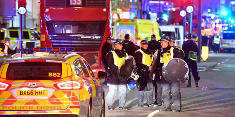 Police officers with riot shields on Borough High Street after the incident in central London. Photo / AP