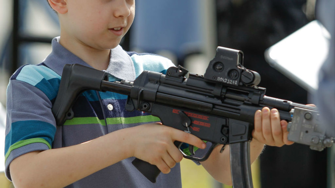 Primary school students were allowed to handle army rifles (Photo / Getty Images)