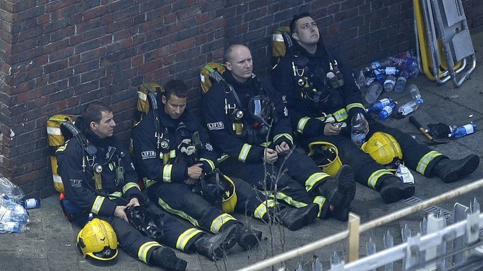 Firefighters rest as they take a break. Photo / AP