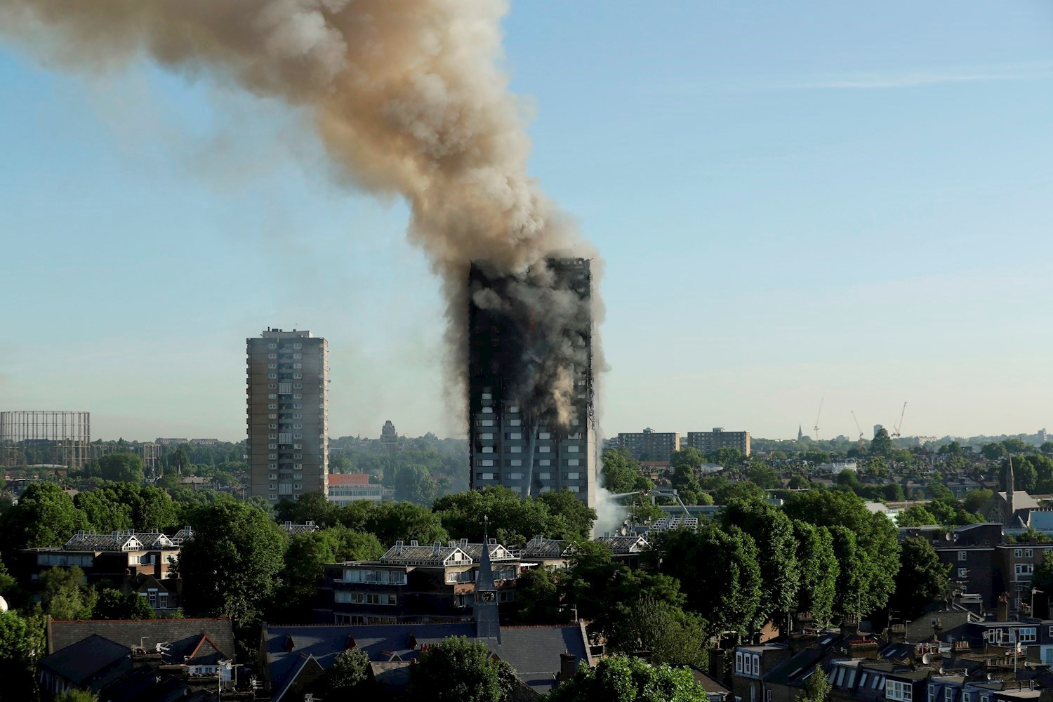 Smoke coming from the 27-storey block of flats after the fire broke out in west London. Photo / AP