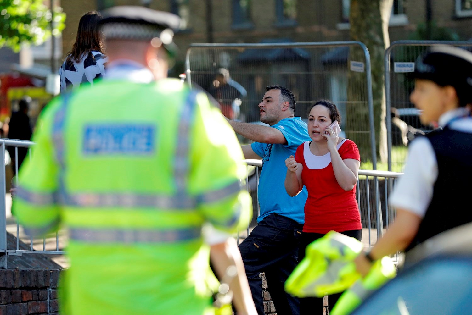 Local residents gather after a massive fire raged in a 27-floor high-rise apartment building. Photo / AP